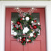 Red and White christmas wreath hanging on door Thumbnail | Christmas World