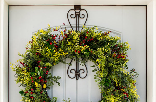 A wreath hanging on a door | Christmas World