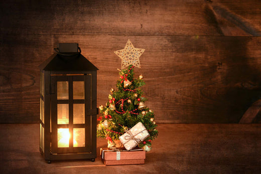 A decorated mini Christmas tree next to a glowing lantern   | Christmas World